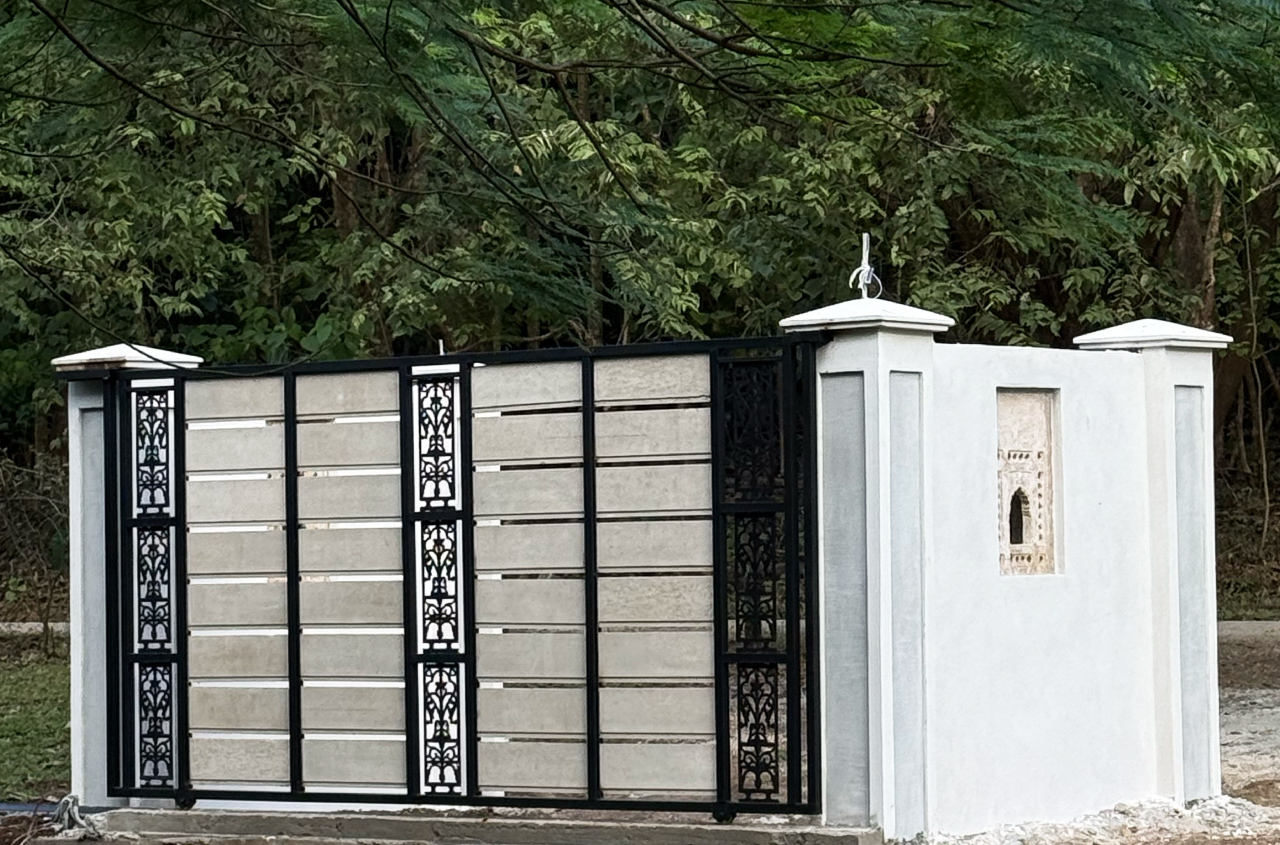 The main entrance of The Sanctuary Estate with cast iron gates and antique stonework