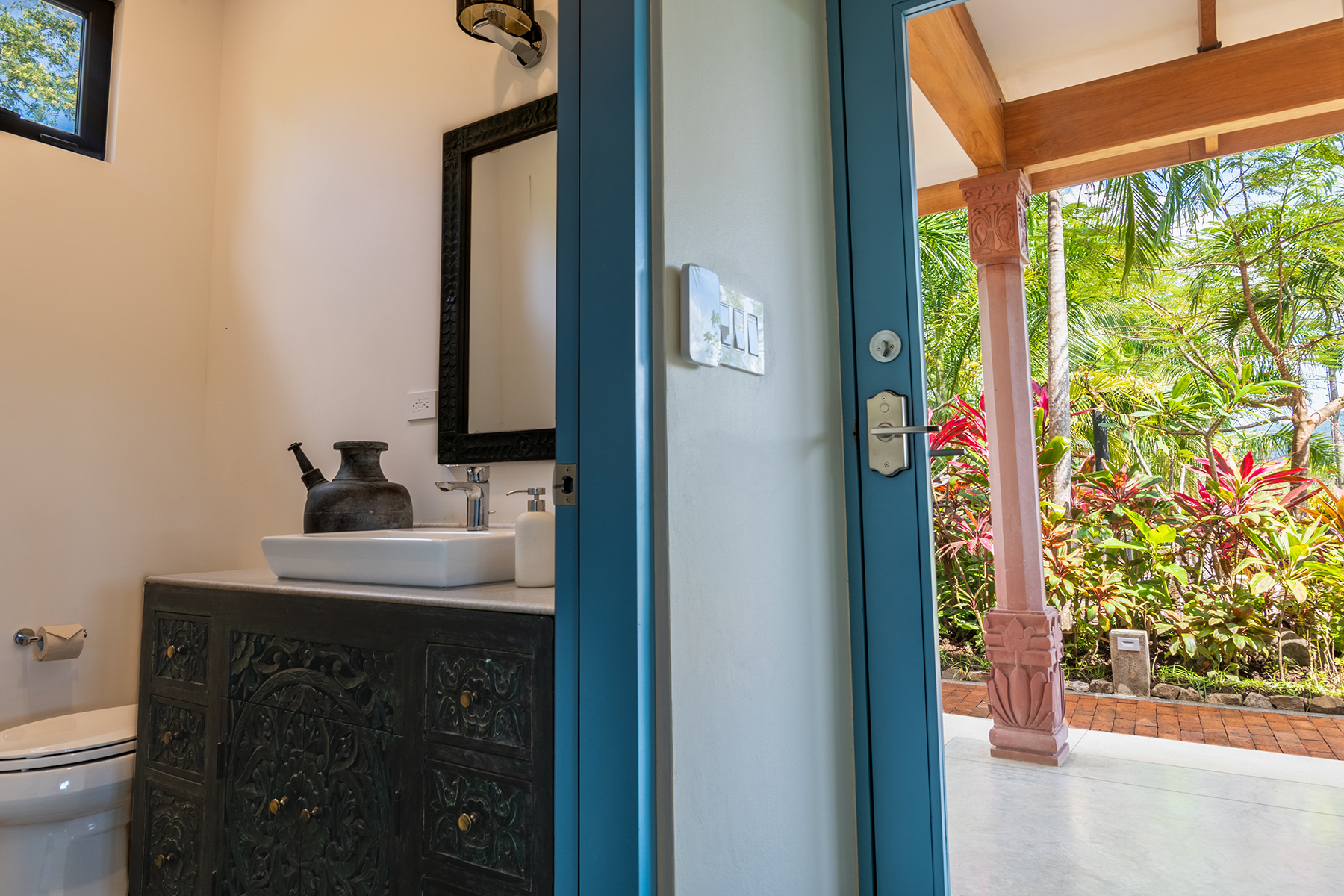 powder room carved vanity — The Sanctuary Estate, Nosara, Costa Rica