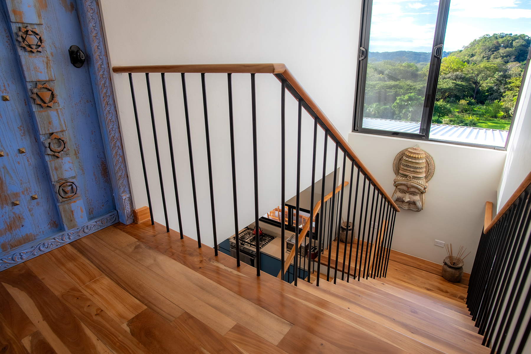 upstairs landing carved door — The Sanctuary Estate, Nosara, Costa Rica