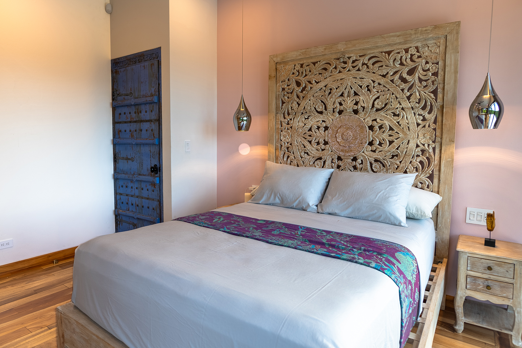 bedroom carved mandala headboard — The Sanctuary Estate, Nosara, Costa Rica