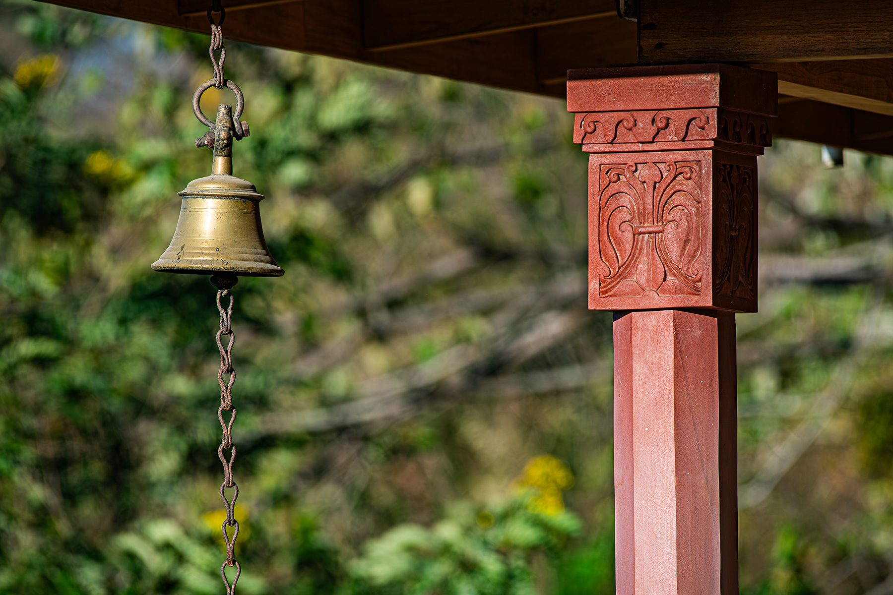 carved pillar brass bell — The Sanctuary Estate, Nosara, Costa Rica